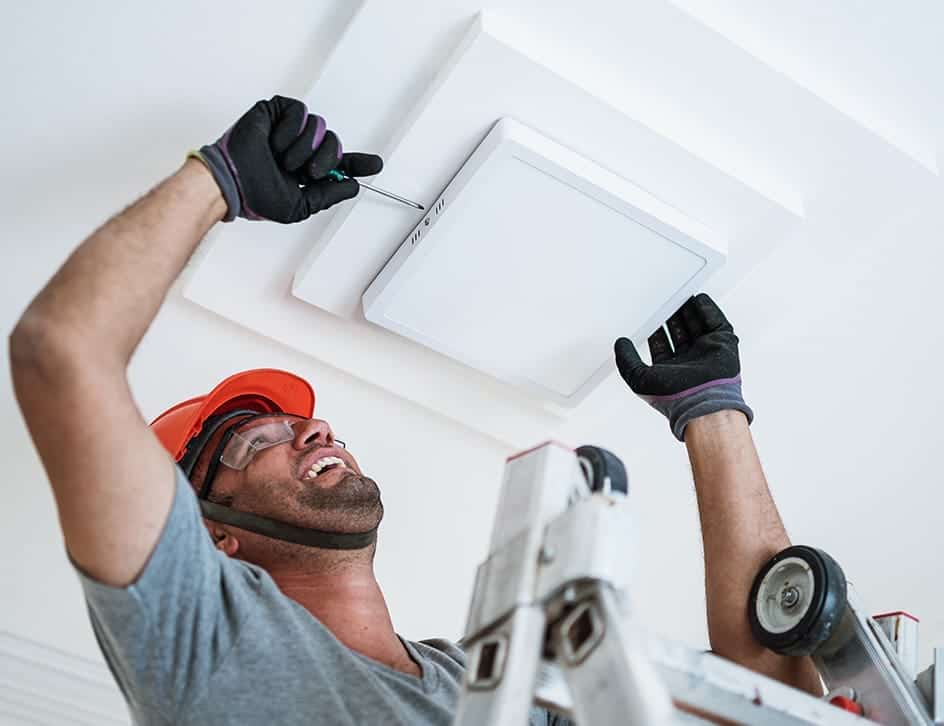 electrician installing led panel lights